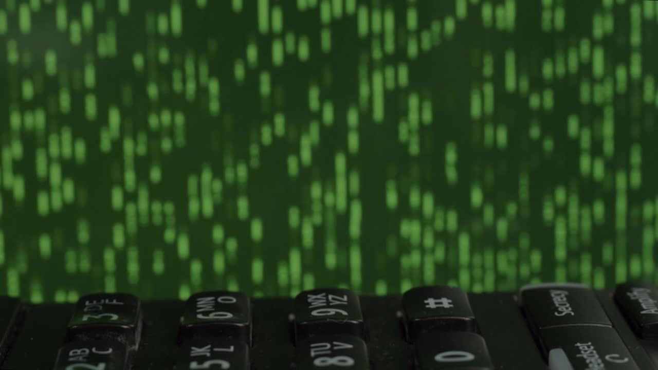 Black phone on desk with green data storm running in background