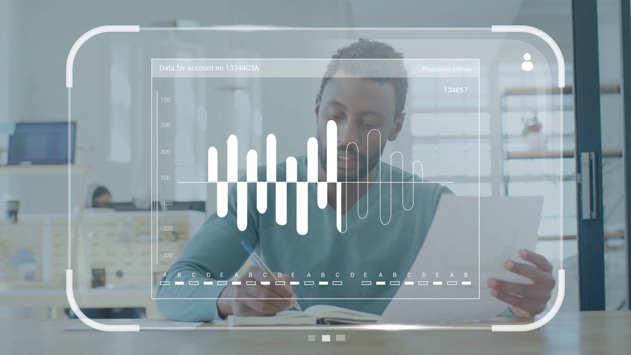 Man leaning and reaching for sheet, bringing AR waveform while reviewing and writing business notes
