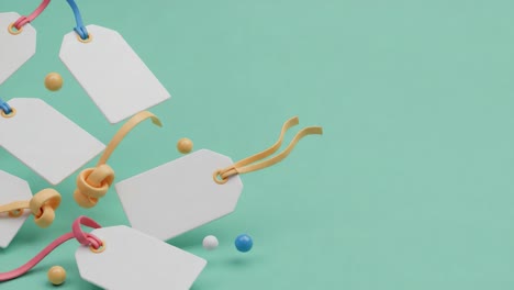 creative arrangement of blank tags and colorful balls on a vibrant background, showcasing an artistic display of labels and playful objects for decorative inspiration