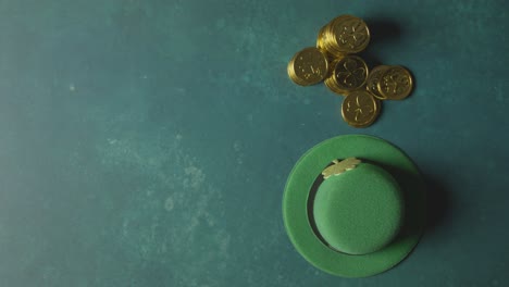 overhead studio shot of green leprechaun top hat and piles of gold coins to celebrate st patricks day 4