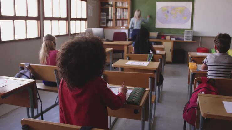 Female teacher teaching group of kids in the class