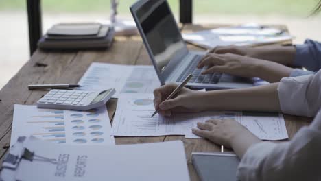 happy asian business woman team meeting brainstorm coworkers project finance graph document work together strategic planning for success enjoy working as a team in the office.