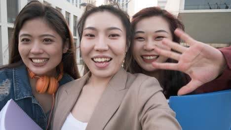 three asian women taking a selfie. student friends on the university campus.