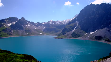 A-foggy-blue-lake-surrounded-by-the-mountain-in-Lunersee,-Austria