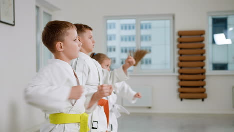 kids in white kimono in martial arts class