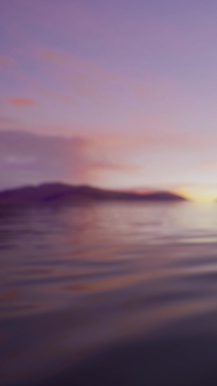 Sunset view over calm water with distant hills and colorful sky in twilight