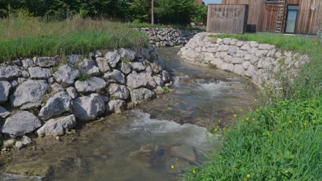 close up of small river inside, flowing thru a small village in austria