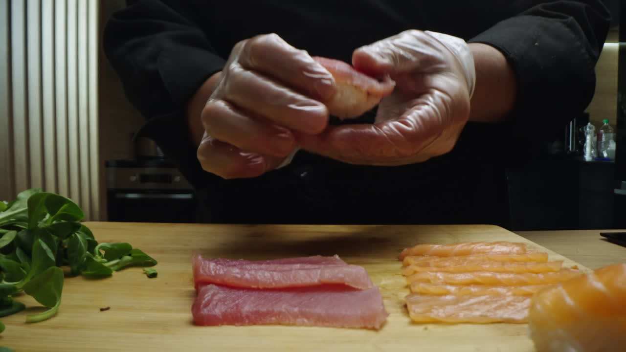 Chef Hands Preparing Fresh Sushi Nigiri with Salmon and Tuna