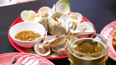 fresh boiled clams served with spicy sauce and cold beer