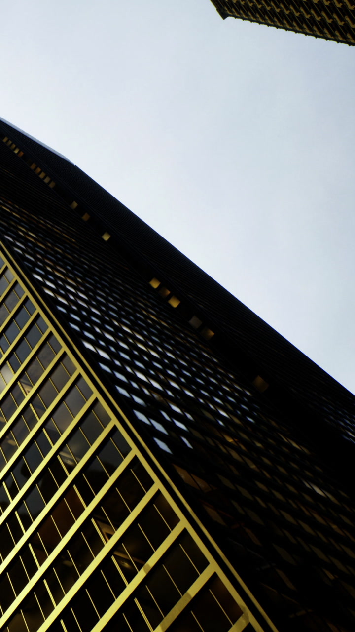 Golden reflections dance on modern architecture under an expansive sky