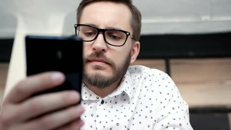 man paying online by bank card at smartphone