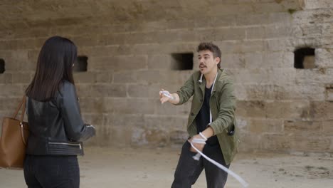 street magician performing rope trick