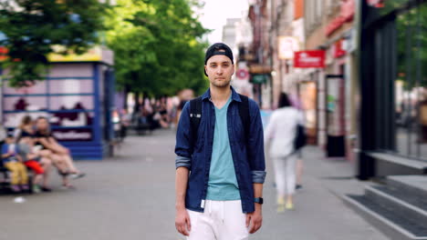 young man standing on a city street