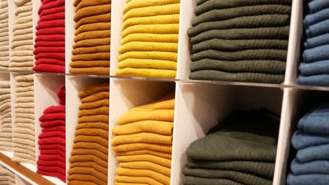 Close-up-of-ful-shirts-on-shelf-in-a-shop-,