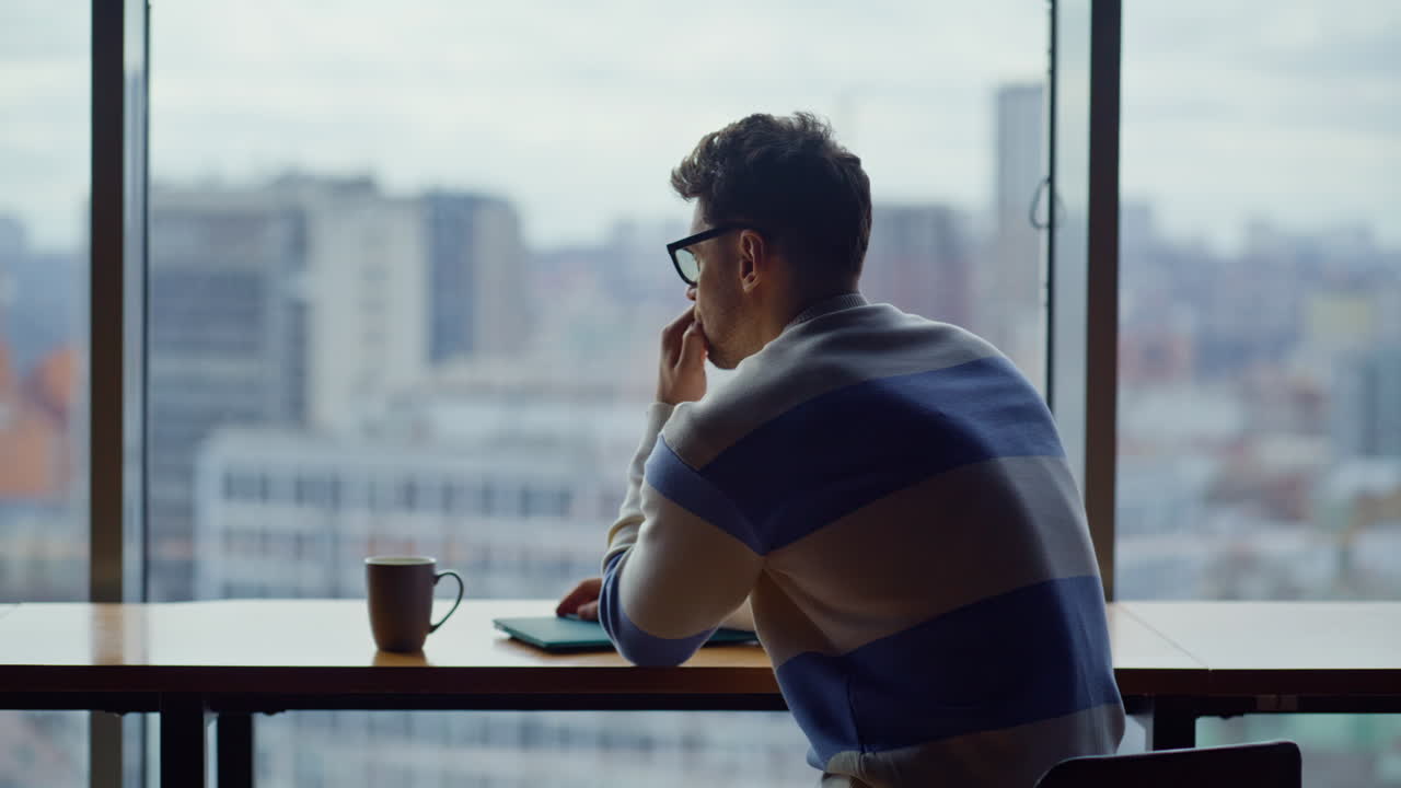 Focused businessman typing laptop panoramic office closeup. Ceo drinking coffee