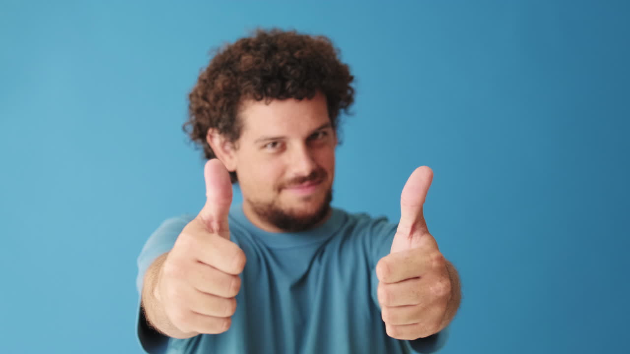 Smiling Man Shows Thumbs Up for Approval