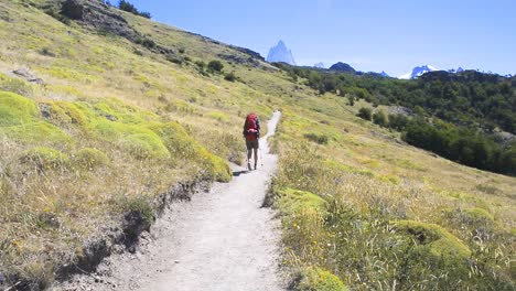 young woman wearing backpack walking on a trail in patagonia, argentina-1