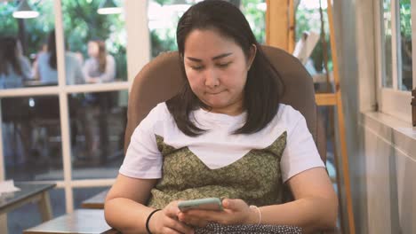 woman using smartphone in coffee cafe