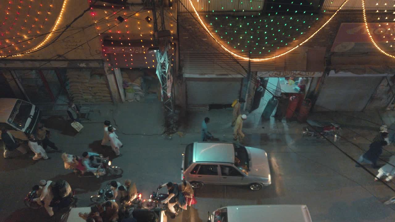 This is a high angle shot of the busy streets of Pakistan on Eid Milad un Nabi looking straight down the streets