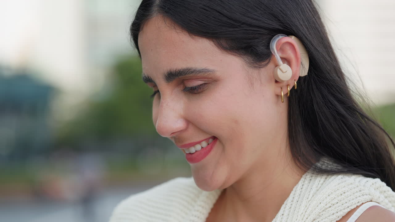 Portrait of a Smiling Woman with a Hearing Aid