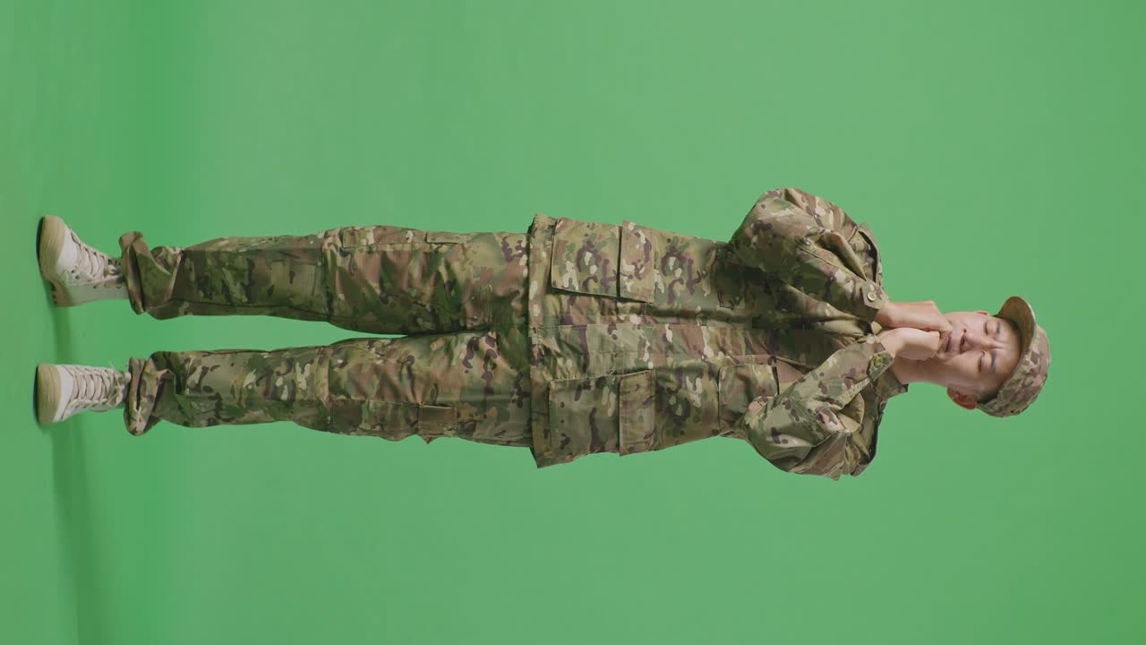 Full Body Of Asian Man Army Soldier Uniform Praying In The Green Screen Background Studio