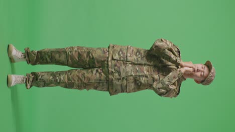 full body of asian man army soldier uniform praying in the green screen background studio