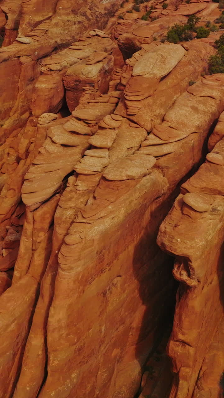 Geological formation in the Arches national Park in Utah, USA. Amazing bare rounded rocks in the shape of plates piled together. Top view. Vertical video