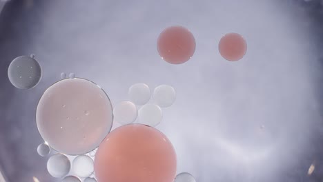 macro abstract peach and clear liquid bubbles merging texture background