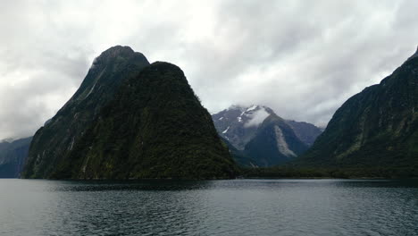 cruising over tranquil waters of harrisons cove, milford sound