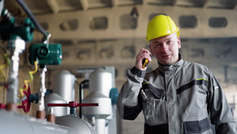 man with yellow hardhat at the factory