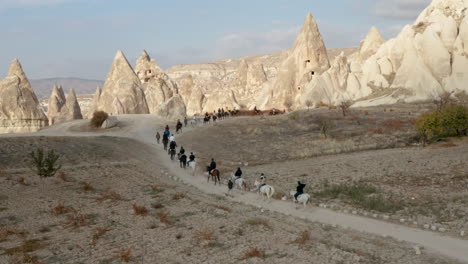 hombres turcos y caravanas de caballos pasando por los paisajes de capadocia, turquía