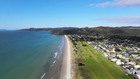 Housing-at-Matarangi,-new-development-beautifuly-located-beside-sandy-beach,-New-Zealand---aerial