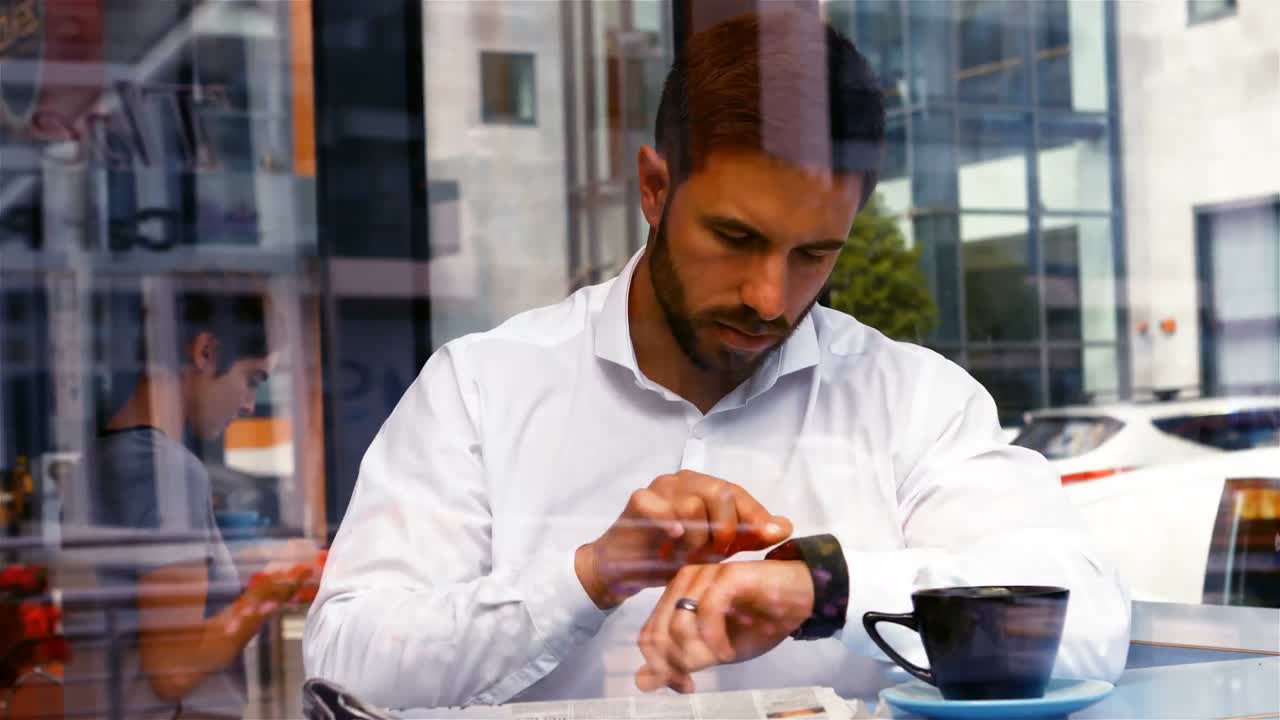 Businessman reading newspaper in office