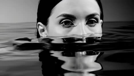 black and white portrait of woman submerged in water