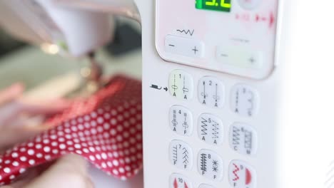 woman using a sewing machine. woman stitching fabric using a sewing machine