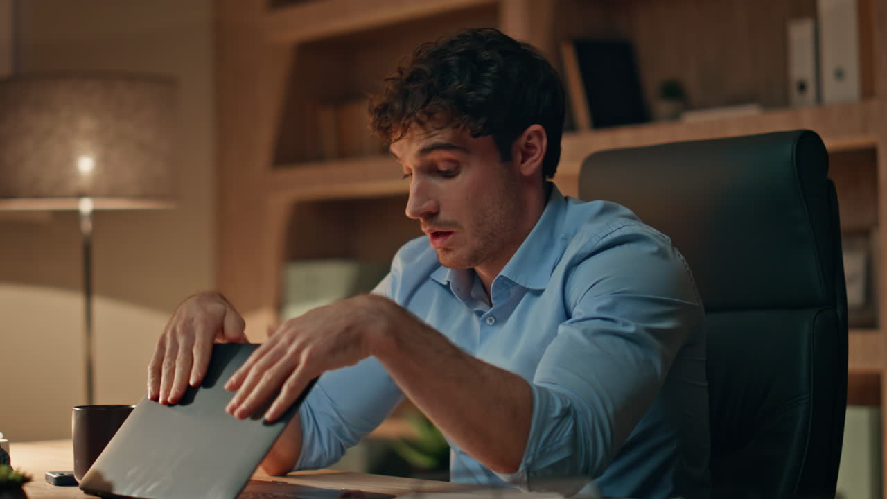 Exhausted freelancer finish work closing laptop late evening close up. Tired man