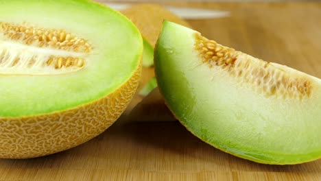Tracking-shot-of-sliced-Galia-melon,-on-a-chopping-board
