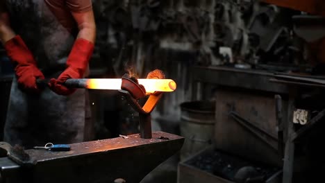 blacksmith forging the molten metal with hammer machine 4k