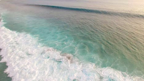 waves crashing over shallow reef