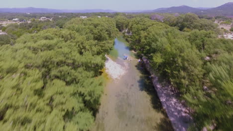 Aerial-shot-of-a-river-in-the-early-afternoon-reflecting-the-tranquility-of-the-clouds-on-its-surface