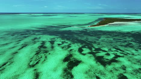 wide aerial view of bahamas flat, island, and boat motoring away