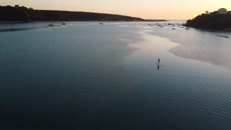 standup paddleboarding along the mira river vila nova de milfontes at dusk