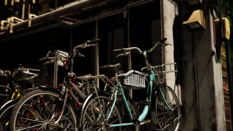 bicycles parked outside a shop on a quiet street in the evening