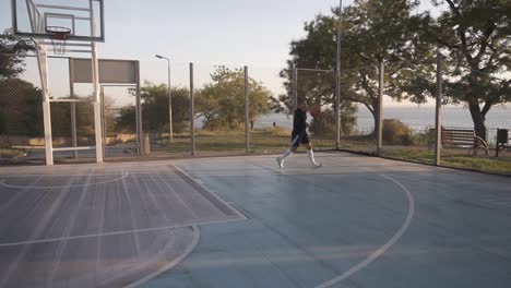 Scene-Of-A-Female-Basketball-Player-Practicing-In-Throwing-The-Ball-To-The-Hoop-On-The-Local-Outdoors-Basketball-Court