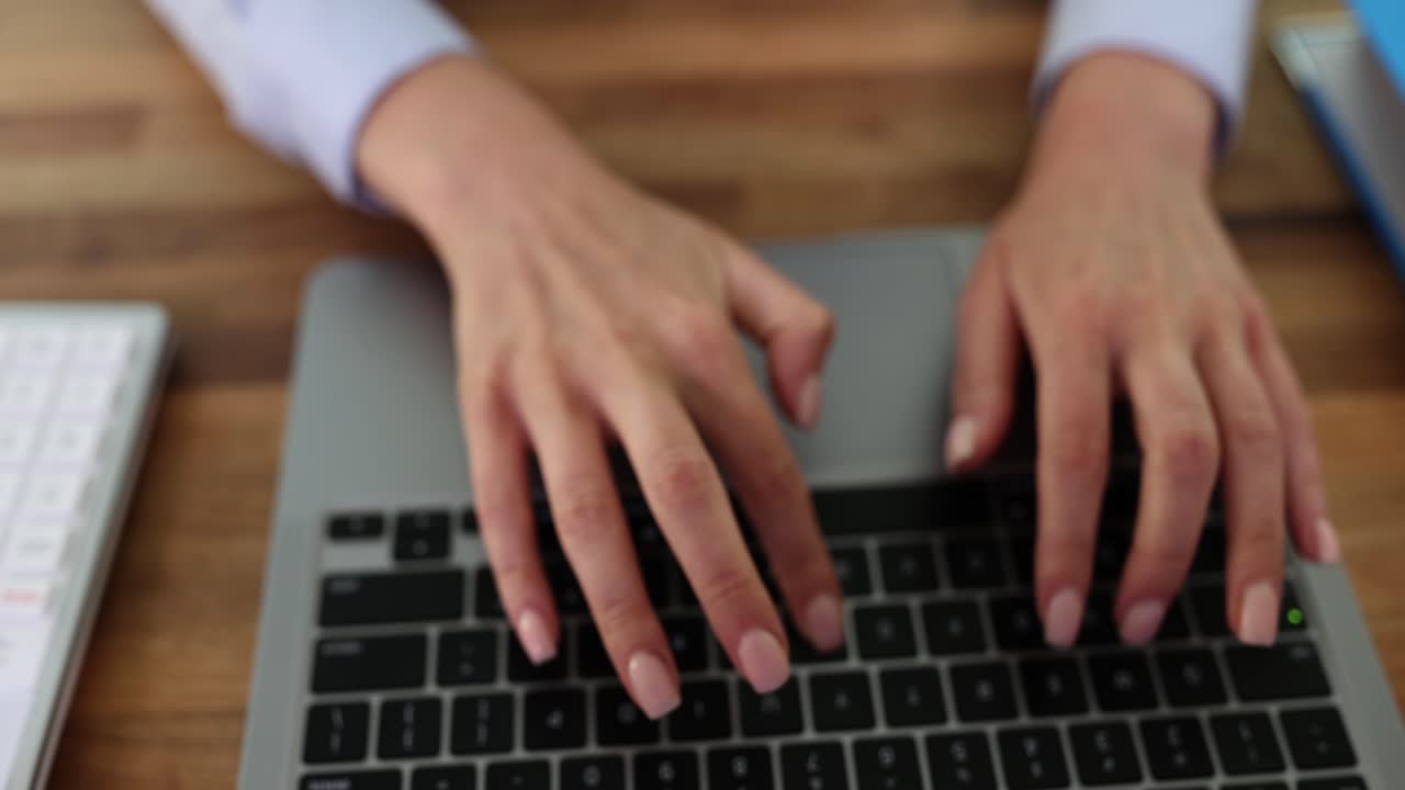 Laptop and Calculator on a Wooden Desk