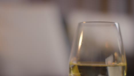 close up of glass of wine on romantic evening at home in lounge