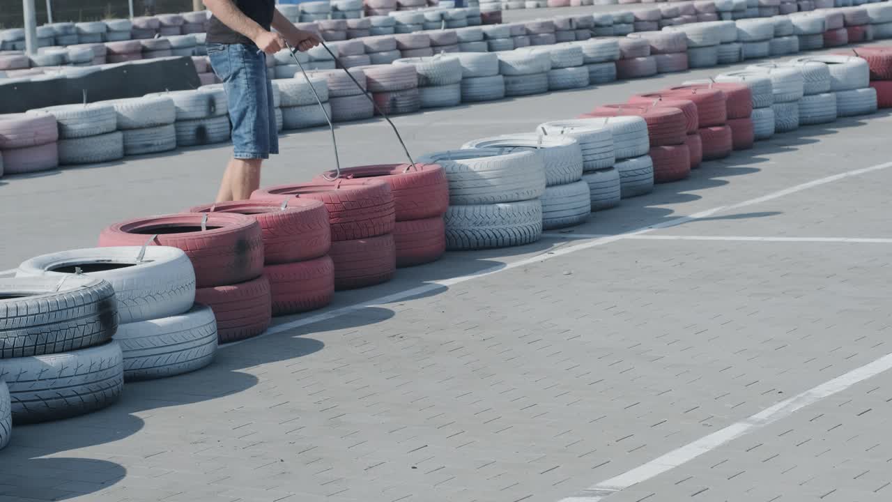 The go kart racing service workers moves wheels at the track