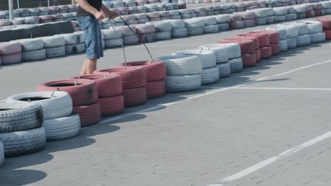 the go kart racing service workers moves wheels at the track