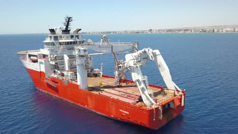 Orbit-shot-Of-Huge-Cable-Installation-Ship-Anchored-In-Larnaca-Blue-Sea,-Cyprus