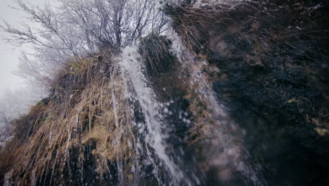 winter waterfall of water drops, ice frost and snowflakes